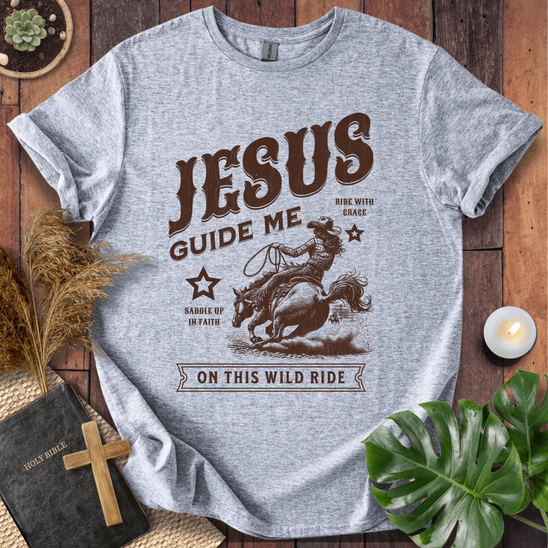 Vintage style t-shirt with a cowgirl riding a horse and text reading Jesus Guide Me On This Wild Ride.