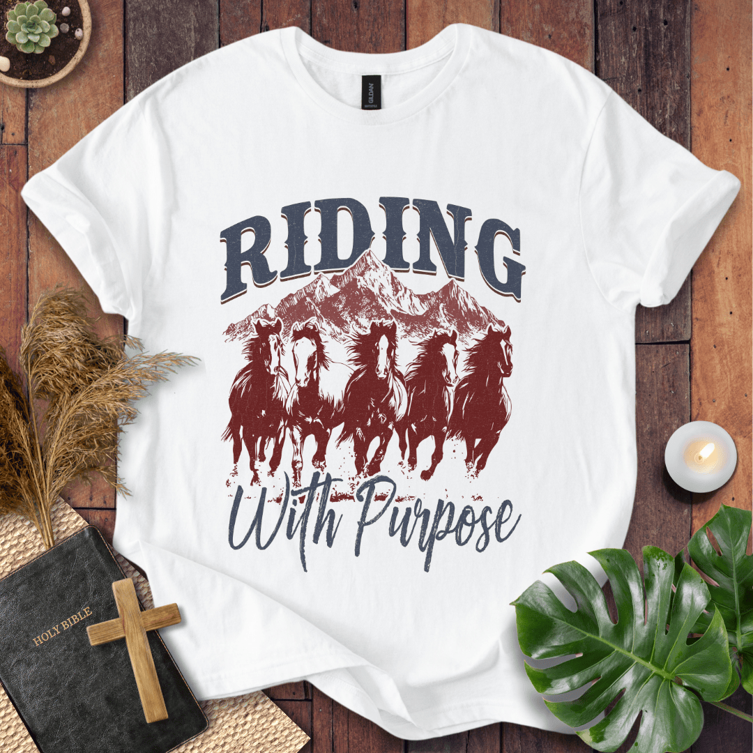 t-shirt with navy and rust graphic of five running horses, mountains, and "Riding With Purpose" vintage text.