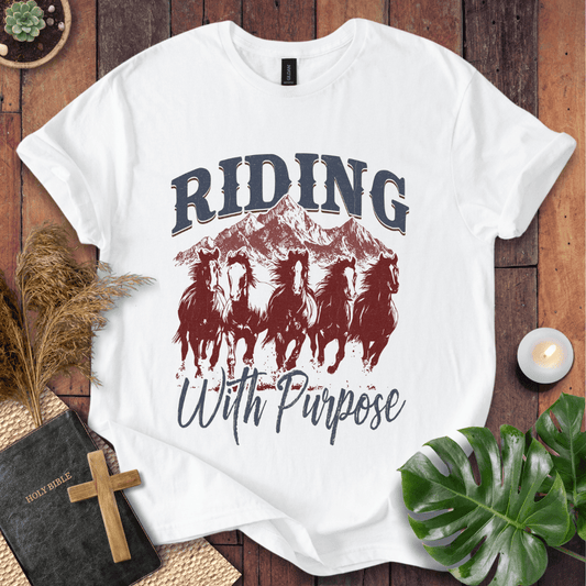 t-shirt with navy and rust graphic of five running horses, mountains, and "Riding With Purpose" vintage text.