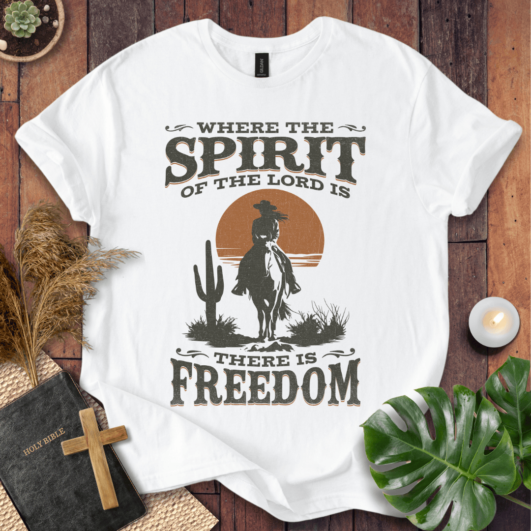 A Western tee featuring a horse rider, cactus, and sunset with the bible verse 2 Corinthians 3:17.