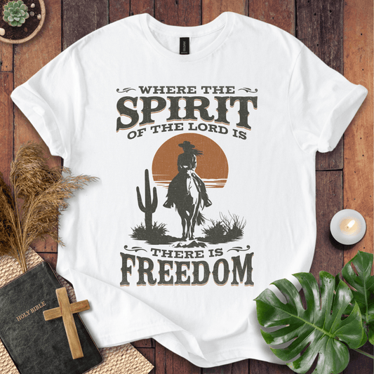 A Western tee featuring a horse rider, cactus, and sunset with the bible verse 2 Corinthians 3:17.