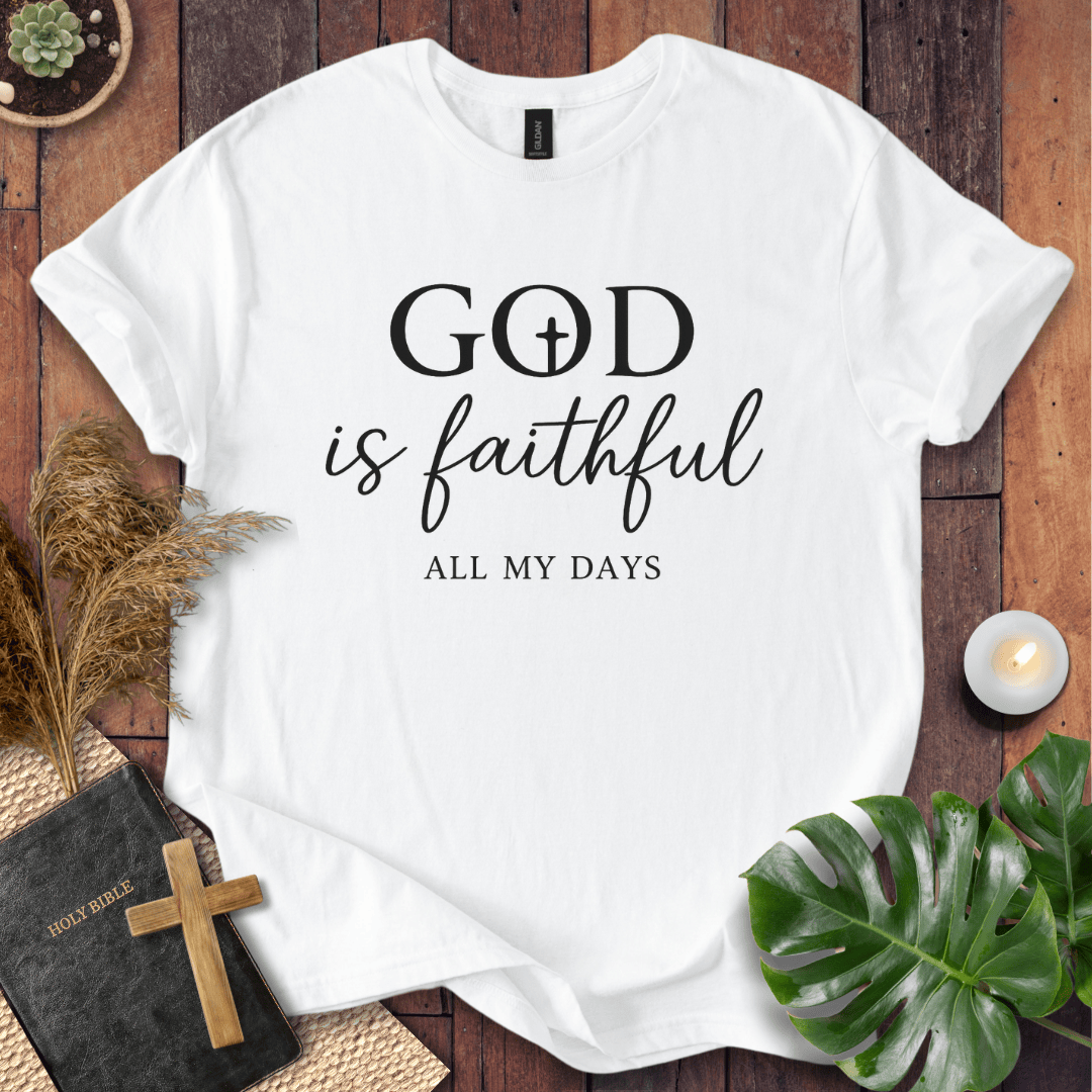 Christian t-shirt reading "God is Faithful All My Days" on a rustic wood background with a Bible and cross.