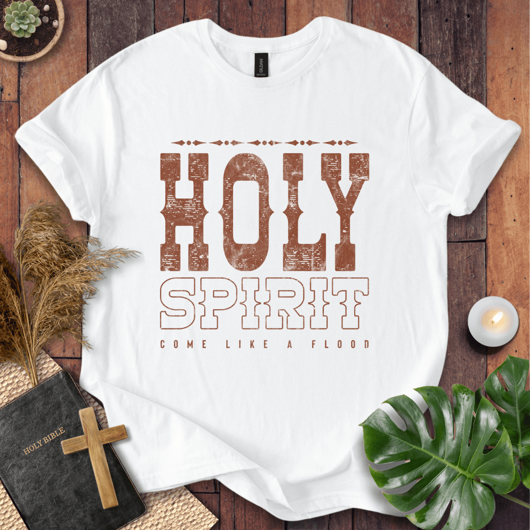 Christian t-shirt with "Holy Spirit Come Like A Flood" in distressed brown western font on a rustic wood background.