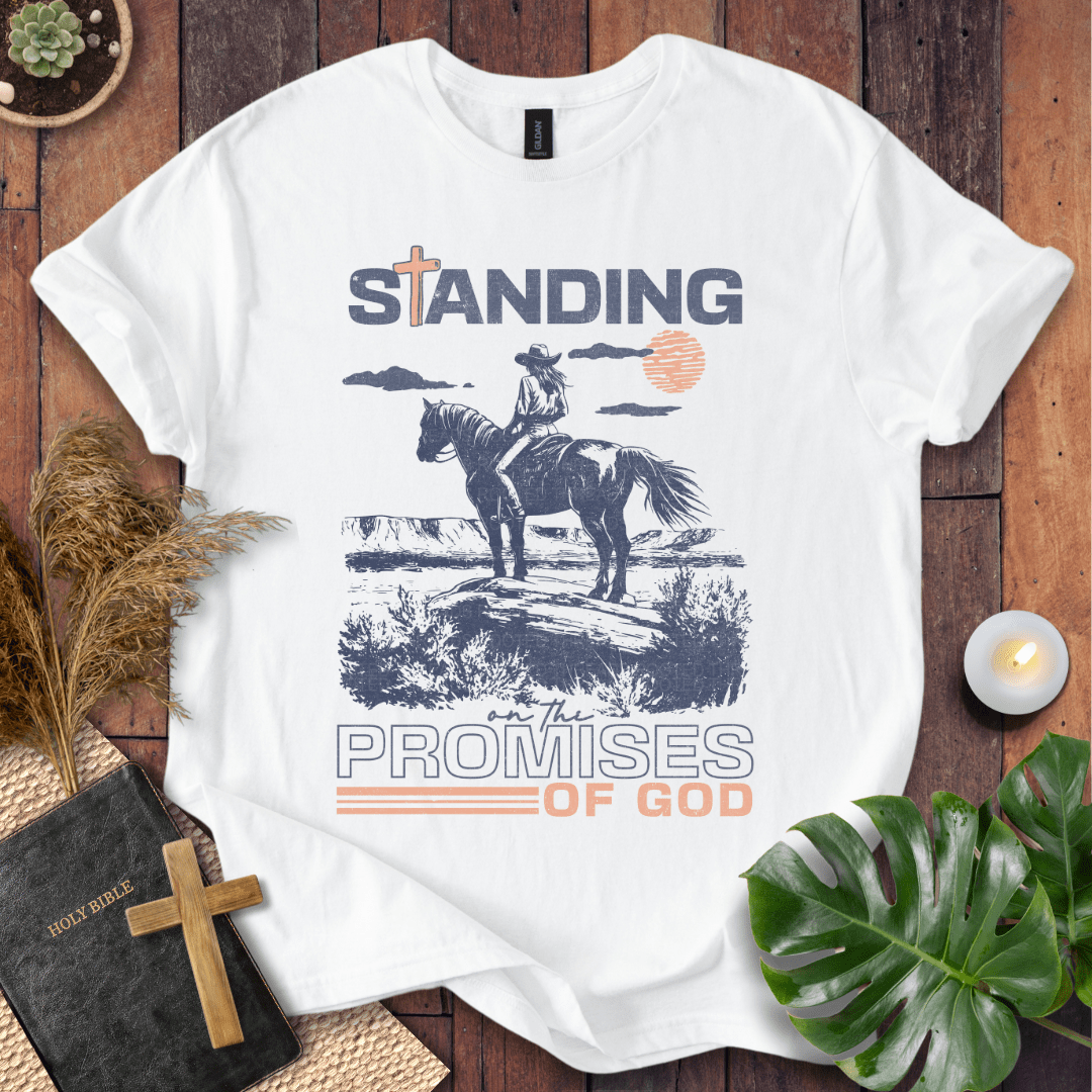 Standing on the Promises of God Christian t-shirt—cowgirl on horseback in western landscape with bold typographic message.